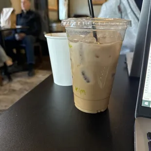 a drink and a remote on a table