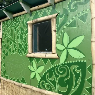 a green wall with a window
