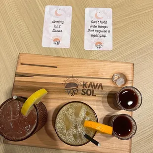 a variety of drinks on a wooden board