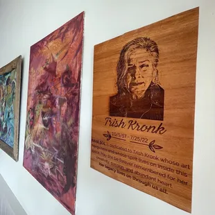 a row of paintings on a wall