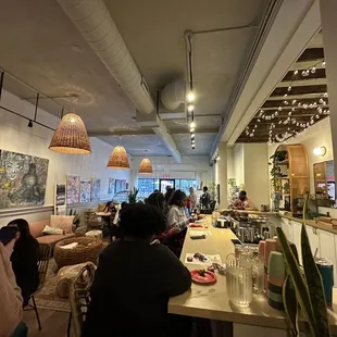 people sitting at tables in a restaurant
