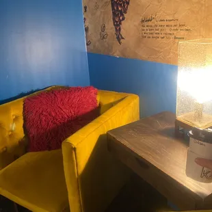 a yellow couch and a coffee cup