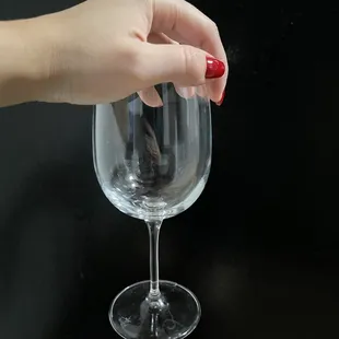 a hand holding a wine glass