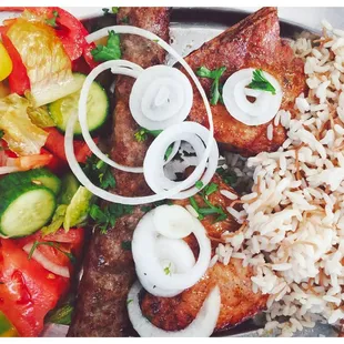 a plate of meat, rice, and vegetables