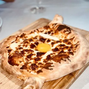 a pizza with an egg on it