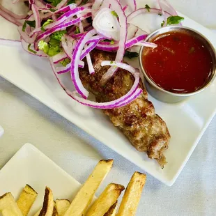 a plate of french fries and a plate of ketchup