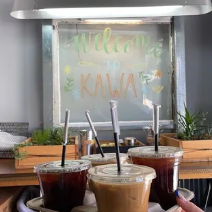 a person holding a tray of coffee