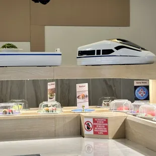 A bullet train carrying the seaweed salad I ordered from the kitchen