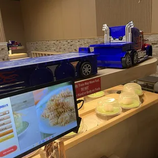 The conveyor belt and "truck" food carrier.