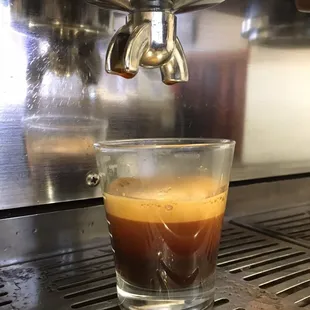 a cup of coffee on a coffee machine