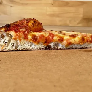 a slice of pizza on a table