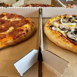 two pizzas in boxes