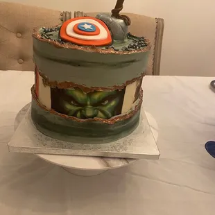 a cake with a captain&apos;s shield on top