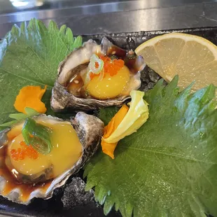 Oyster toped with quail egg and served with Ponzu sauce.