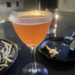 a glass of wine and a plate of french fries