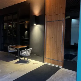 a patio with a table and chairs