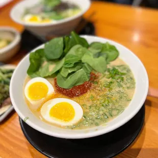 a bowl of ramen with eggs and spinach