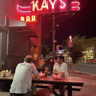 two people sitting at a picnic table