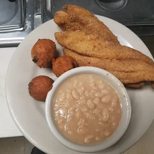 a plate of fried fish and beans