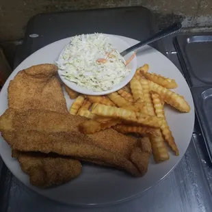 a plate of fried fish, fries, coleslaw and coleslaw