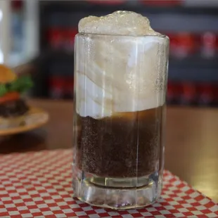 A frosty root-beer float along with a tasty burger and fries.