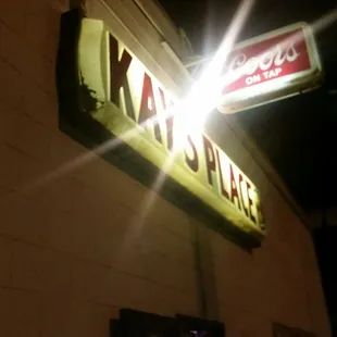 the neon sign for kay's place