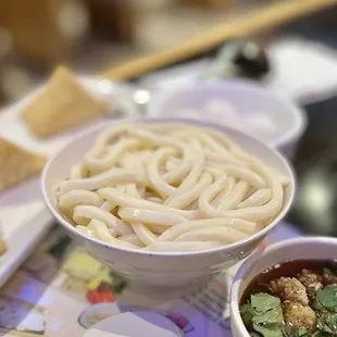 a bowl of noodles and a bowl of soup