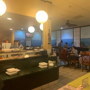 people sitting at tables in a restaurant