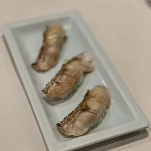 three pieces of sushi on a plate
