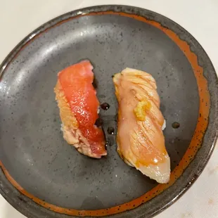 two pieces of sushi on a plate