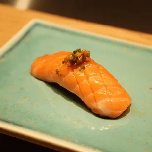 a piece of salmon on a blue plate