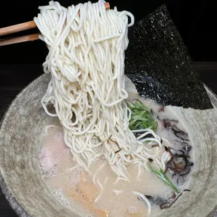 a bowl of ramen with chopsticks
