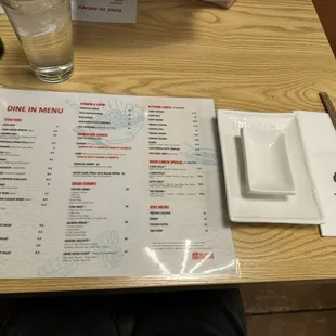 a menu and a glass of water