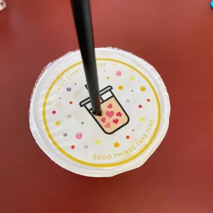 a paper plate with a drink on it