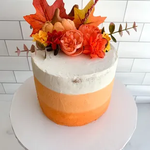 a cake decorated with fall leaves