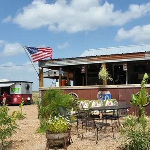 a table and chairs in front of a bbq
