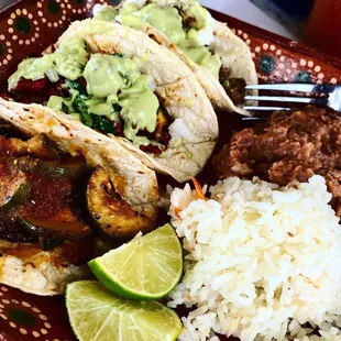 Vegetarian, Al Pastor and Bison tacos with rice, beans and green chile