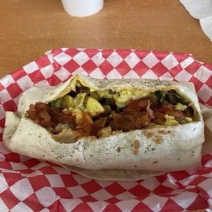 Loaded breakfast burrito sliced open to see the insides.
