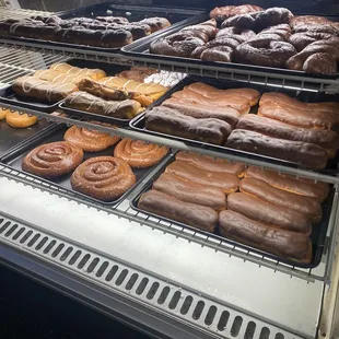 a variety of donuts in a display case