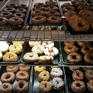 a variety of donuts in a display case