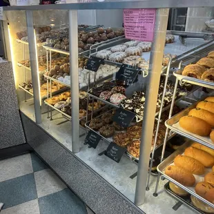 a variety of donuts in a display case