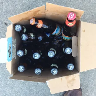 a cardboard box full of beer bottles