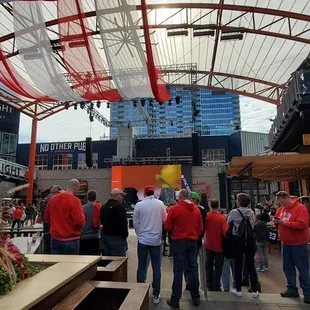 Low big screen behind Badger fans and PA speakers.