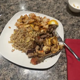Fried rice, shrimp, lobster and steak.