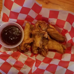 a basket of fried chicken wings with ketchup