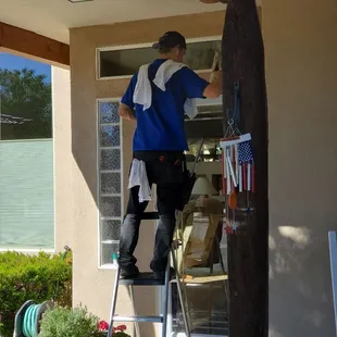 The bossman Dave washing a client's window
