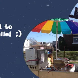 a dog sitting under an umbrella