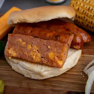 ows a bbq sandwich with corn on the cob
