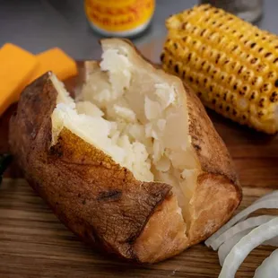 ows a baked potato with a side of vegetables