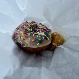 Yummy sprinkle donut and a couple donut holes